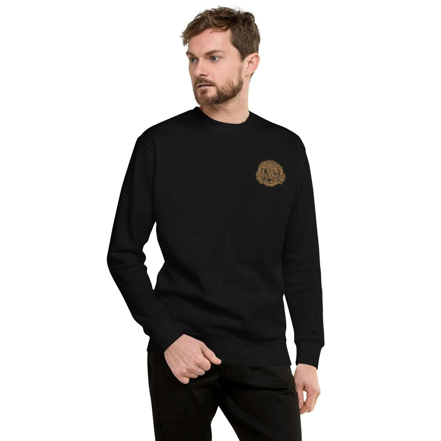 Man wearing black premium unisex sweatshirt with detailed brown poodle embroidery on chest