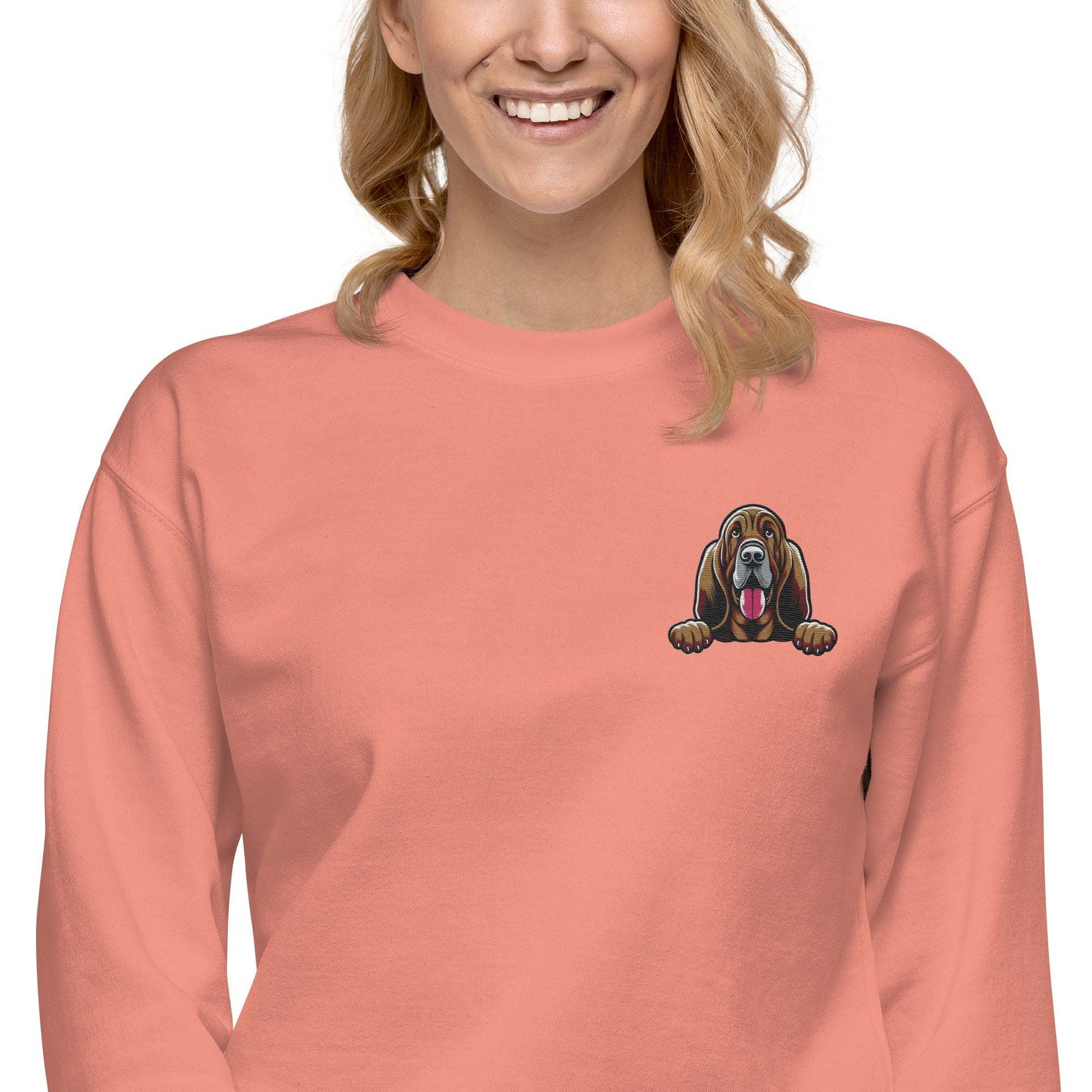 Unisex sweatshirt with detailed Bloodhound dog embroidery on coral fabric