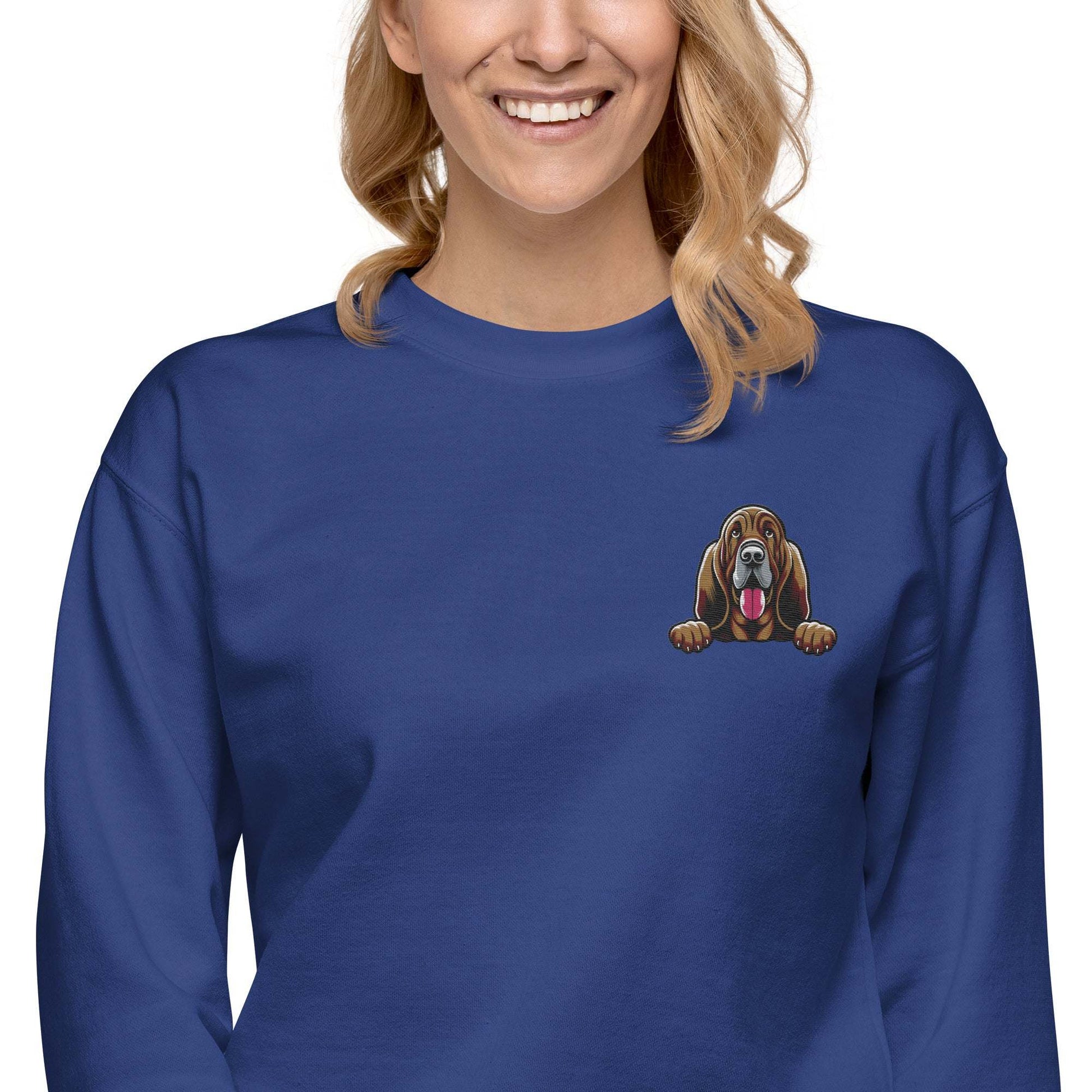Unisex blue sweatshirt with embroidered Bloodhound dog design on chest showcasing detailed droopy ears and inquisitive expression.