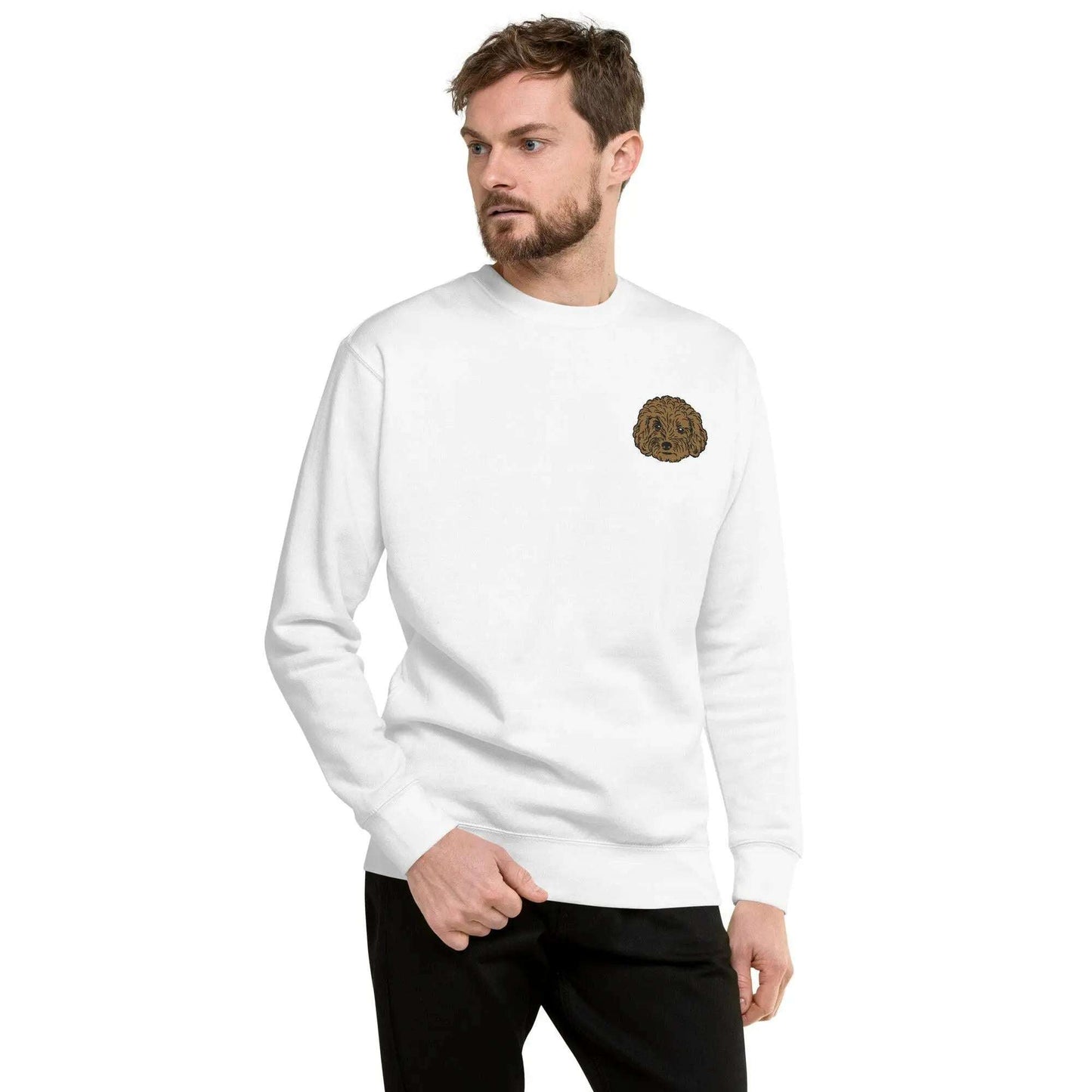 White unisex sweatshirt with detailed brown poodle embroidery on chest, featuring soft premium fabric and ribbed crew neck.