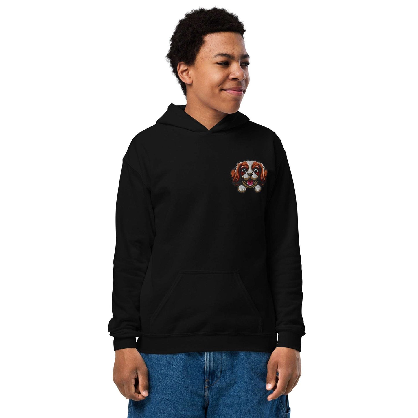 Youth unisex black hoodie with embroidered Cavalier King Charles Spaniel dog face on chest, featuring soft cotton blend fabric and front pouch pocket.